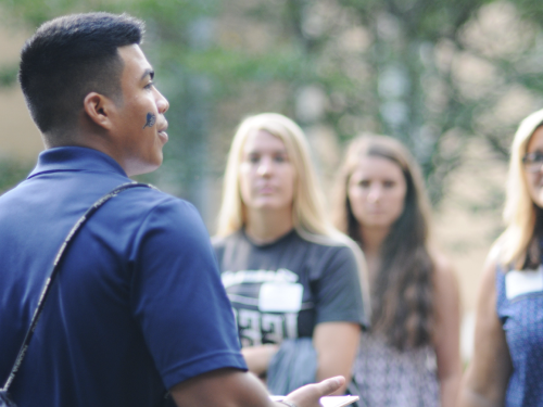 Student addressing a group of people